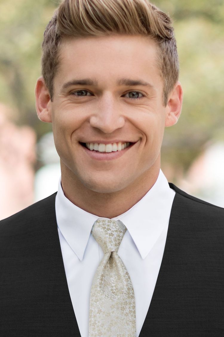 Man wearing a Floral Champagne Windsor Tie with a black vest