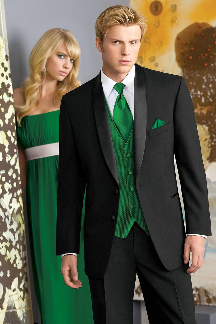 A prom couple in kelly green dress and vest with the black cyprus prom tuxedo