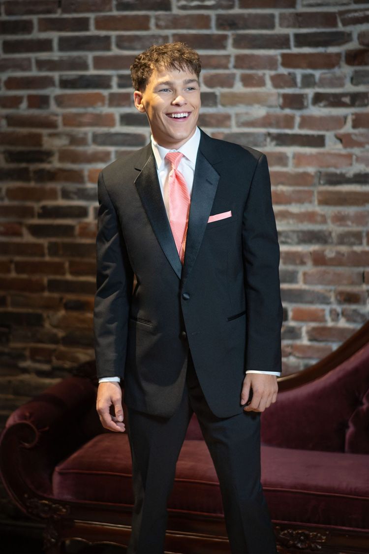 Guy in coral vest and tie in the Black Troy Prom Tuxedo